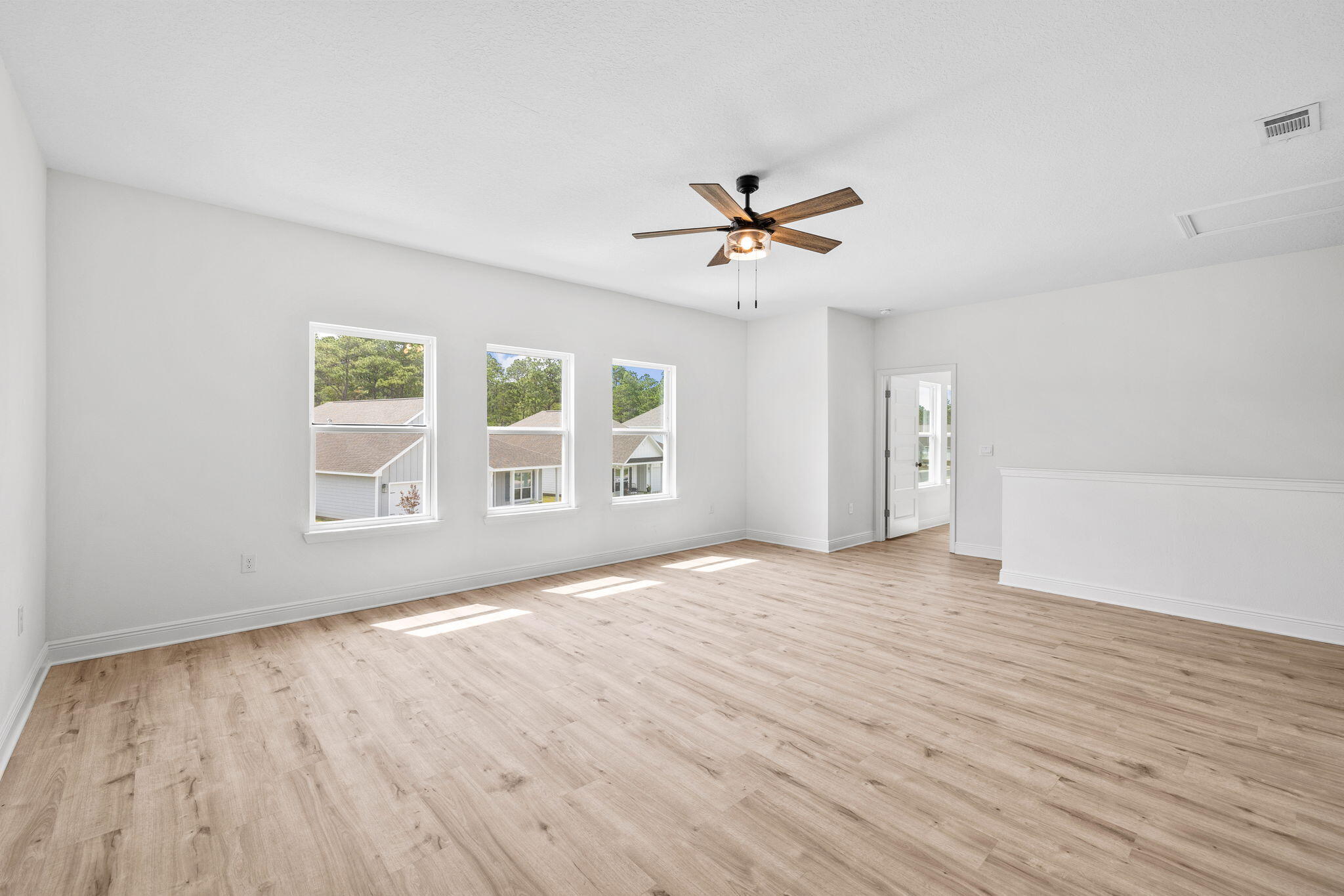 100 JRS Way Santa Rosa Beach, FL 32459 - Photo 36 of 74 a view of an empty room with a window and wooden floor