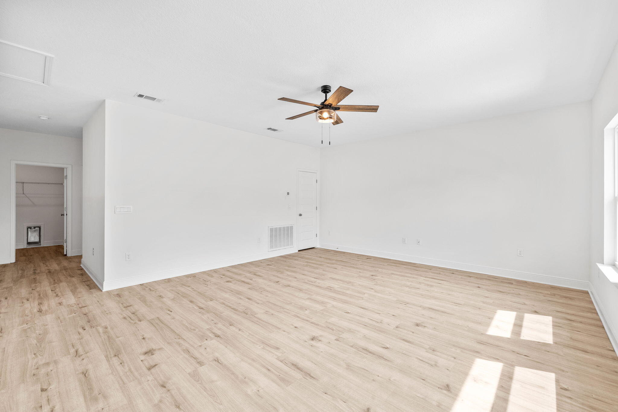 100 JRS Way Santa Rosa Beach, FL 32459 - Photo 39 of 74 a view of a big room with wooden floor and a chandelier fan