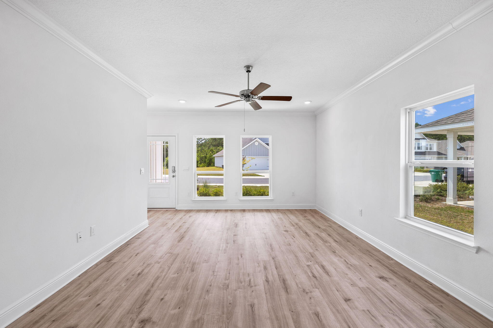 100 JRS Way Santa Rosa Beach, FL 32459 - Photo 46 of 74 an empty room with wooden floor chandelier fan and windows