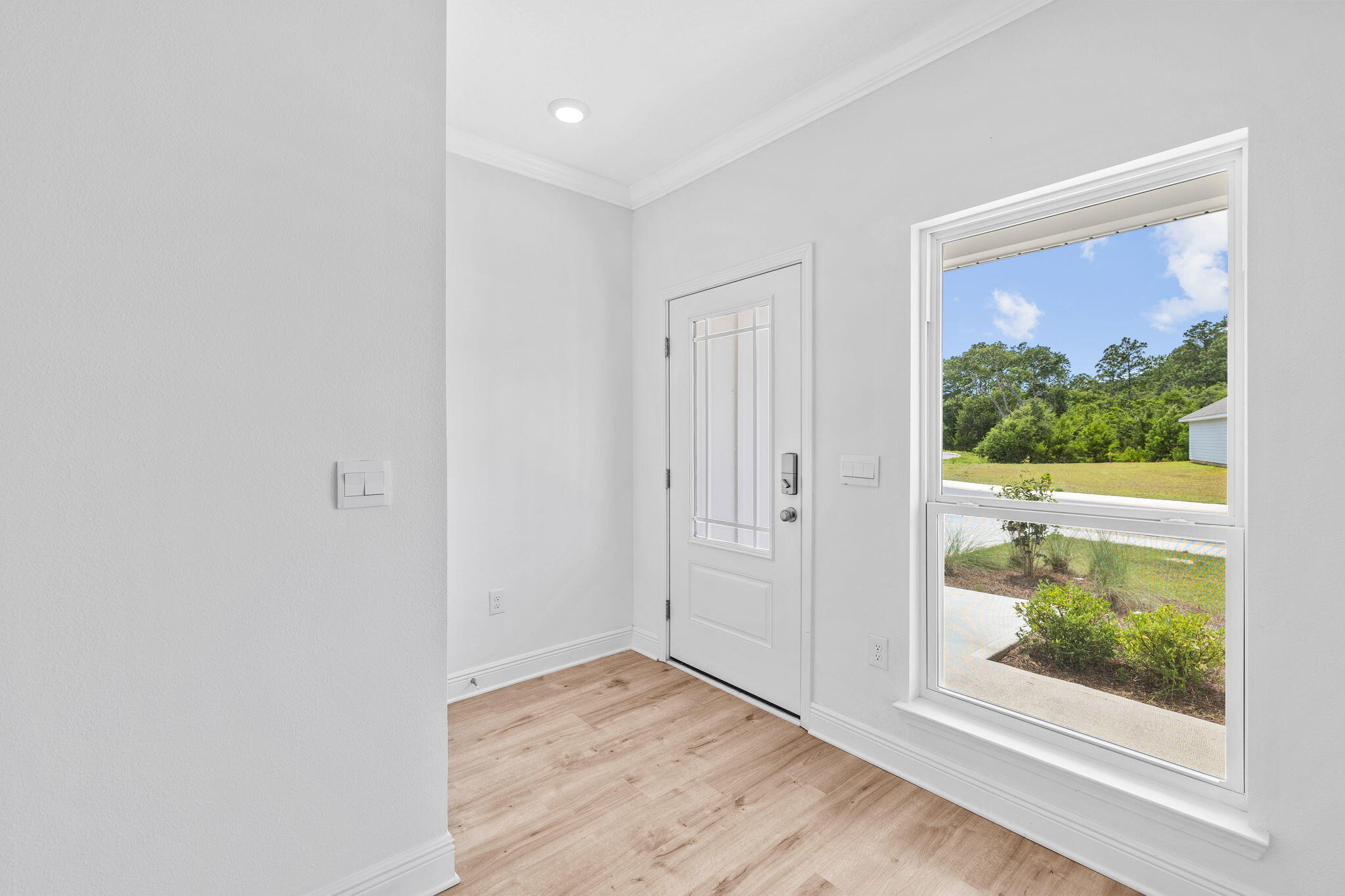100 JRS Way Santa Rosa Beach, FL 32459 - Photo 6 of 74 a view of an empty room with wooden floor and a window