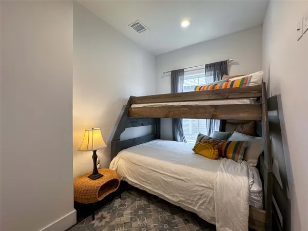 a bedroom with a bed and a lamp