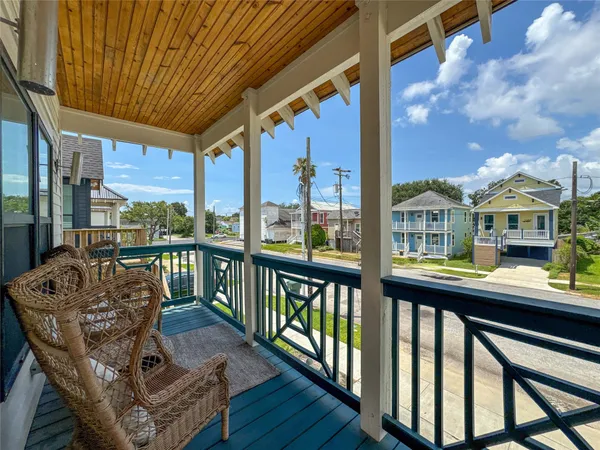 a balcony with furniture and wooden floor