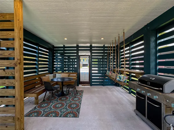 a view of an empty room with stairs and furniture