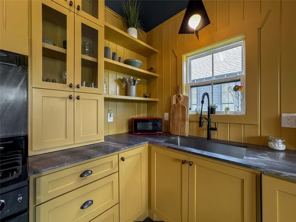 a kitchen with stainless steel appliances granite countertop a sink and cabinets