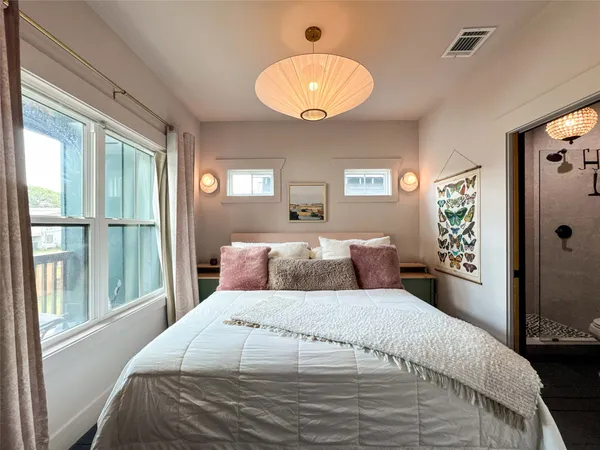 a bedroom with a large bed and a large window