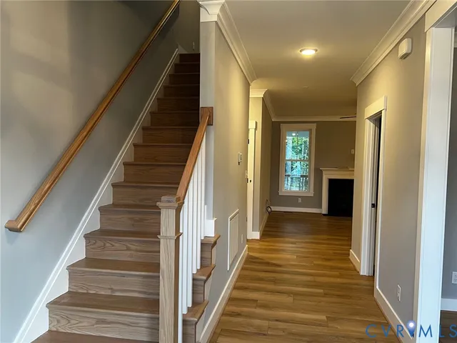 a large kitchen with stainless steel appliances a large counter top a fireplace and a chandelier