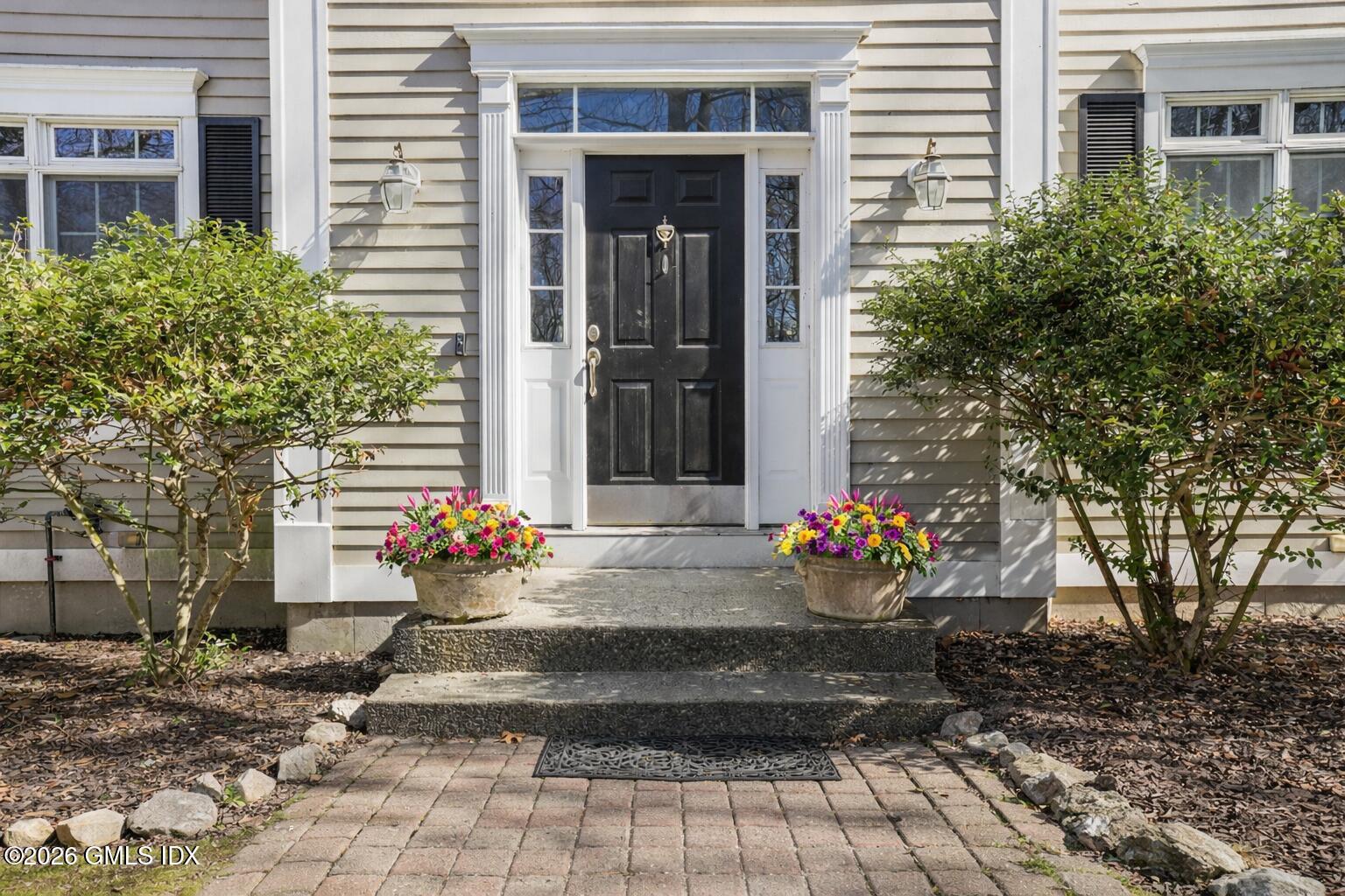 83 Westport Road Wilton, CT 06897 - Photo 1 of 45 a view of a house with potted plants