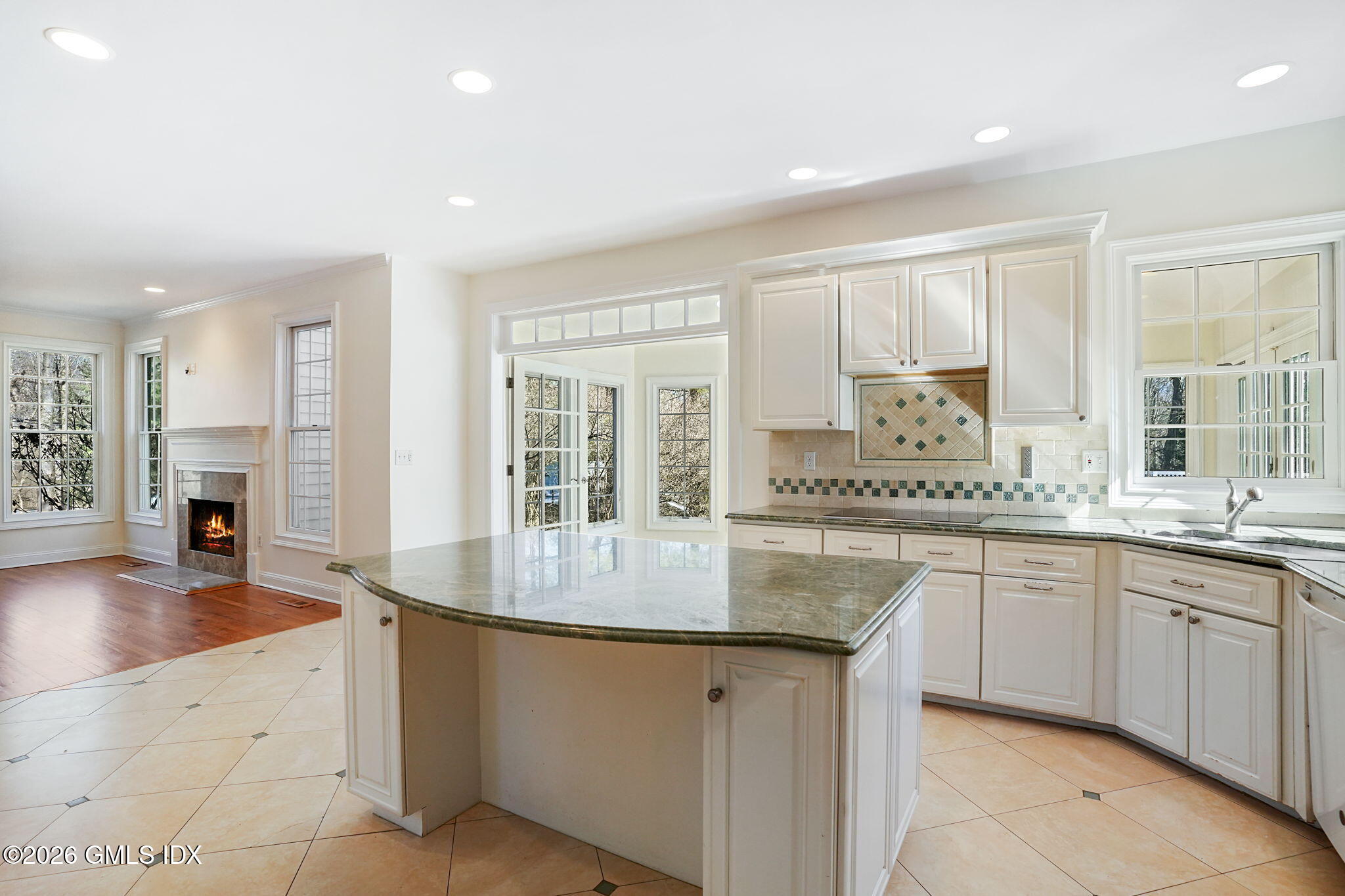 83 Westport Road Wilton, CT 06897 - Photo 11 of 45 a kitchen with granite countertop a sink and dishwasher with a large kitchen island