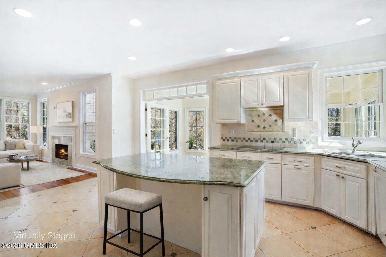 83 Westport Road Wilton, CT 06897 - Photo 12 of 45 a kitchen with granite countertop a sink and white cabinets