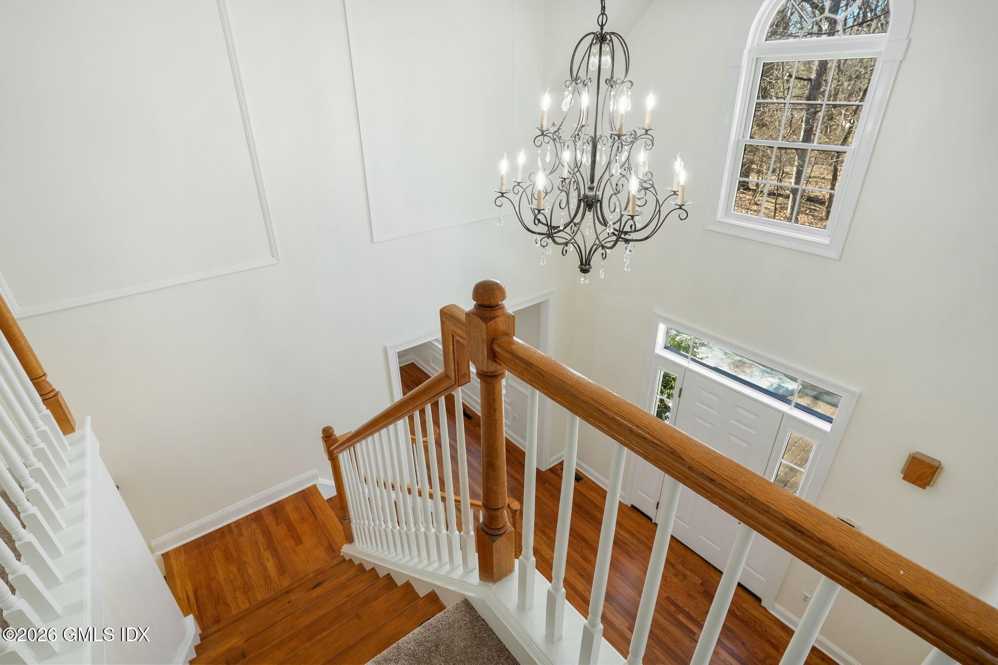 83 Westport Road Wilton, CT 06897 - Photo 16 of 45 a view of staircase with railing and chandelier