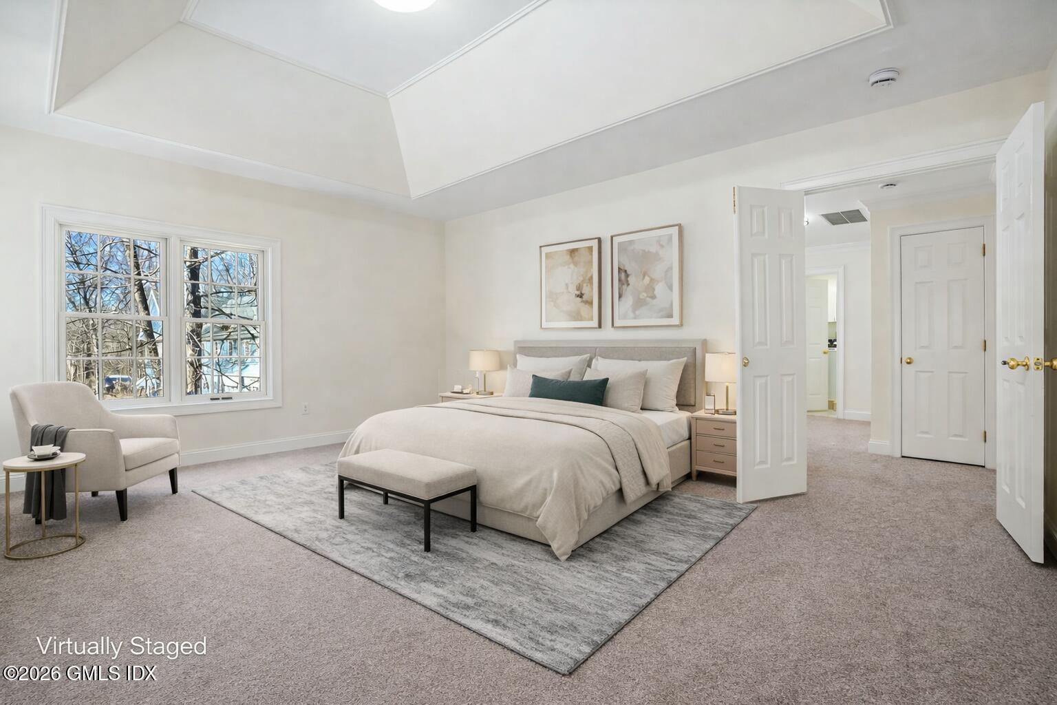 83 Westport Road Wilton, CT 06897 - Photo 18 of 45 a spacious bedroom with a bed a couch and a window