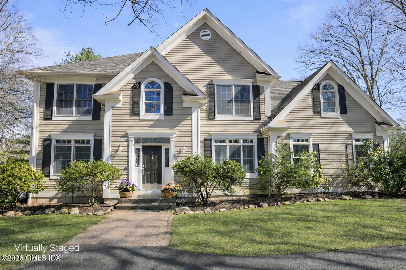 83 Westport Road Wilton, CT 06897 - Photo 2 of 45 a front view of a house with a yard