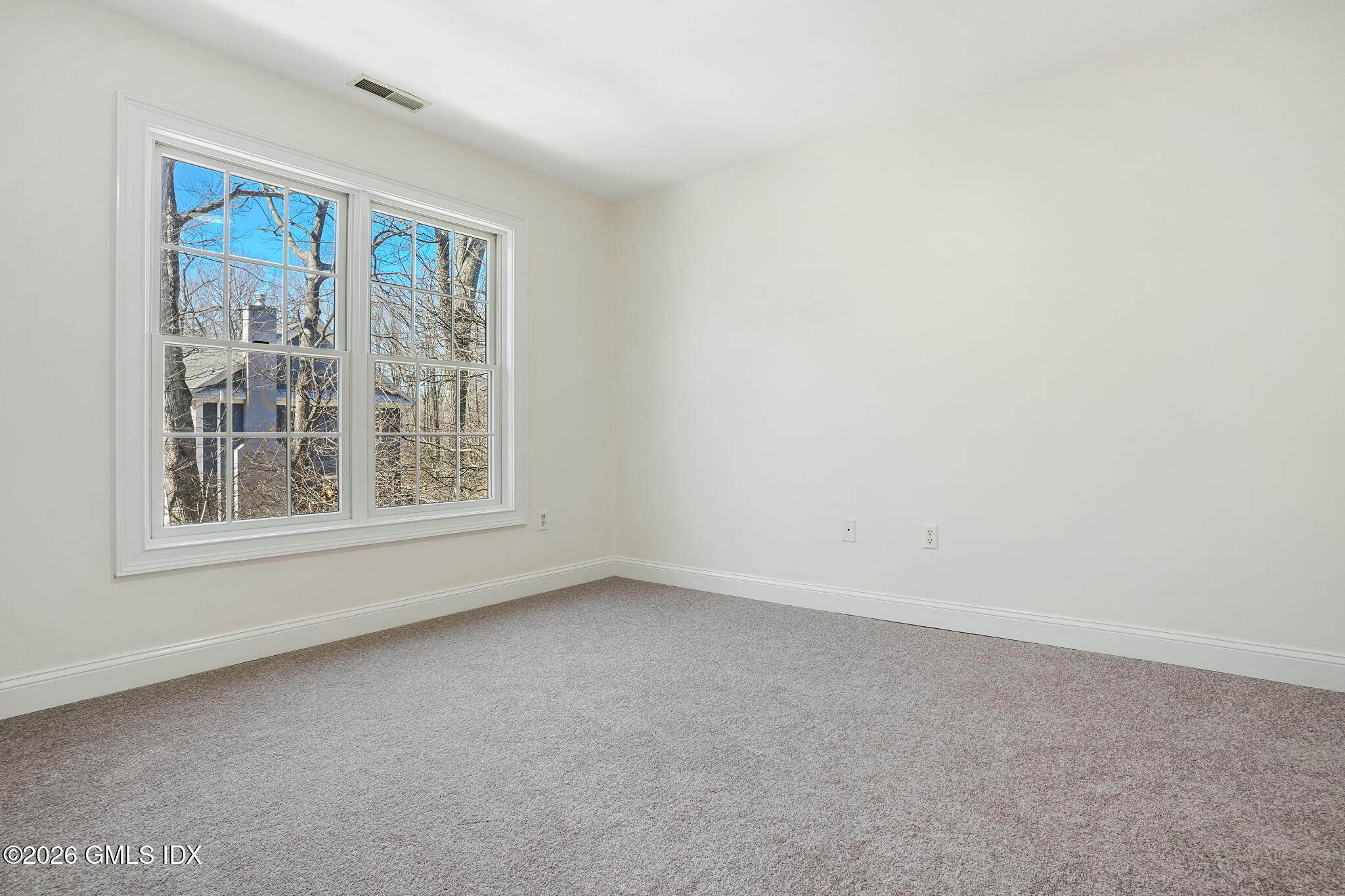 83 Westport Road Wilton, CT 06897 - Photo 25 of 45 an empty room with a window