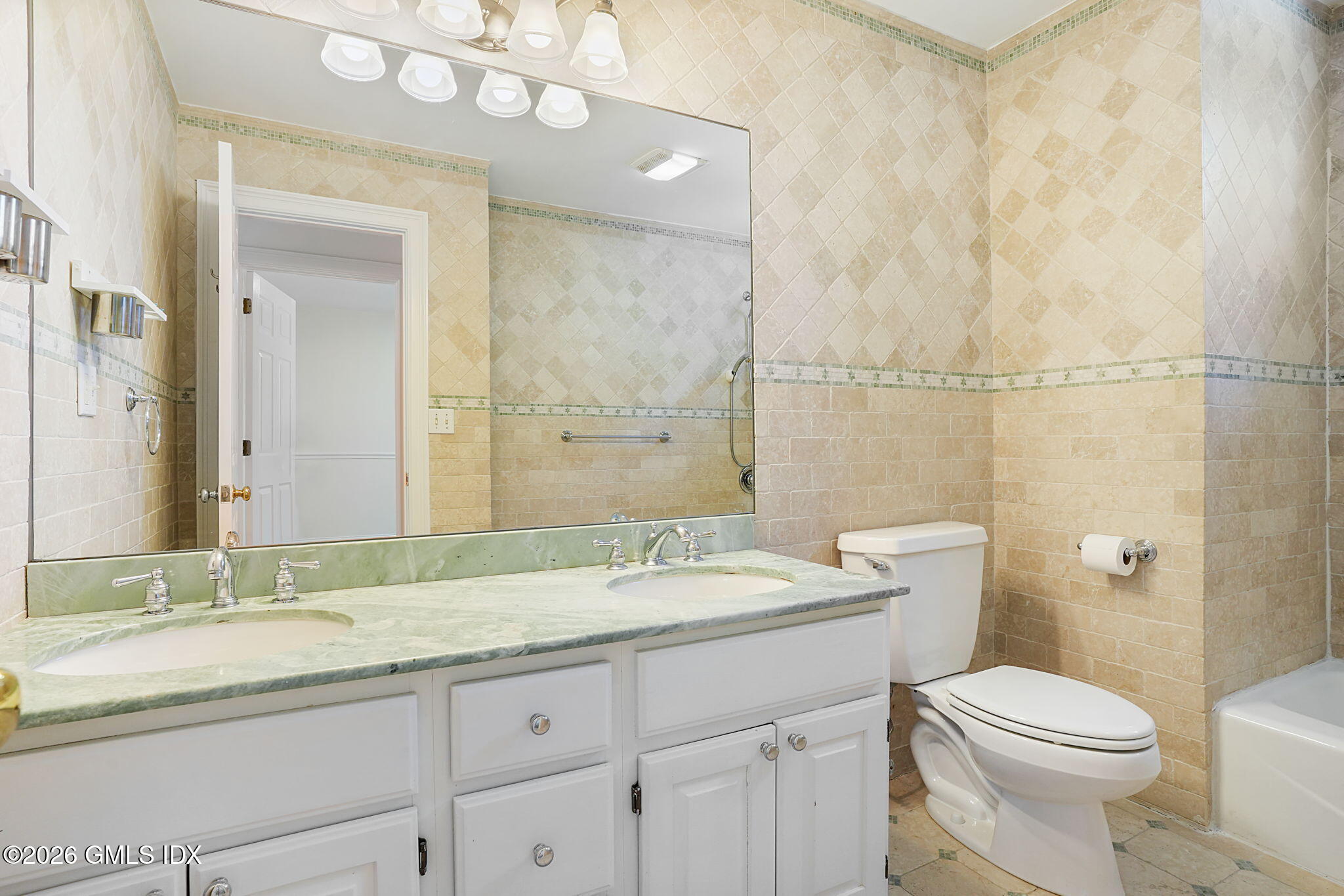 83 Westport Road Wilton, CT 06897 - Photo 29 of 45 a bathroom with a granite countertop sink a mirror and a toilet