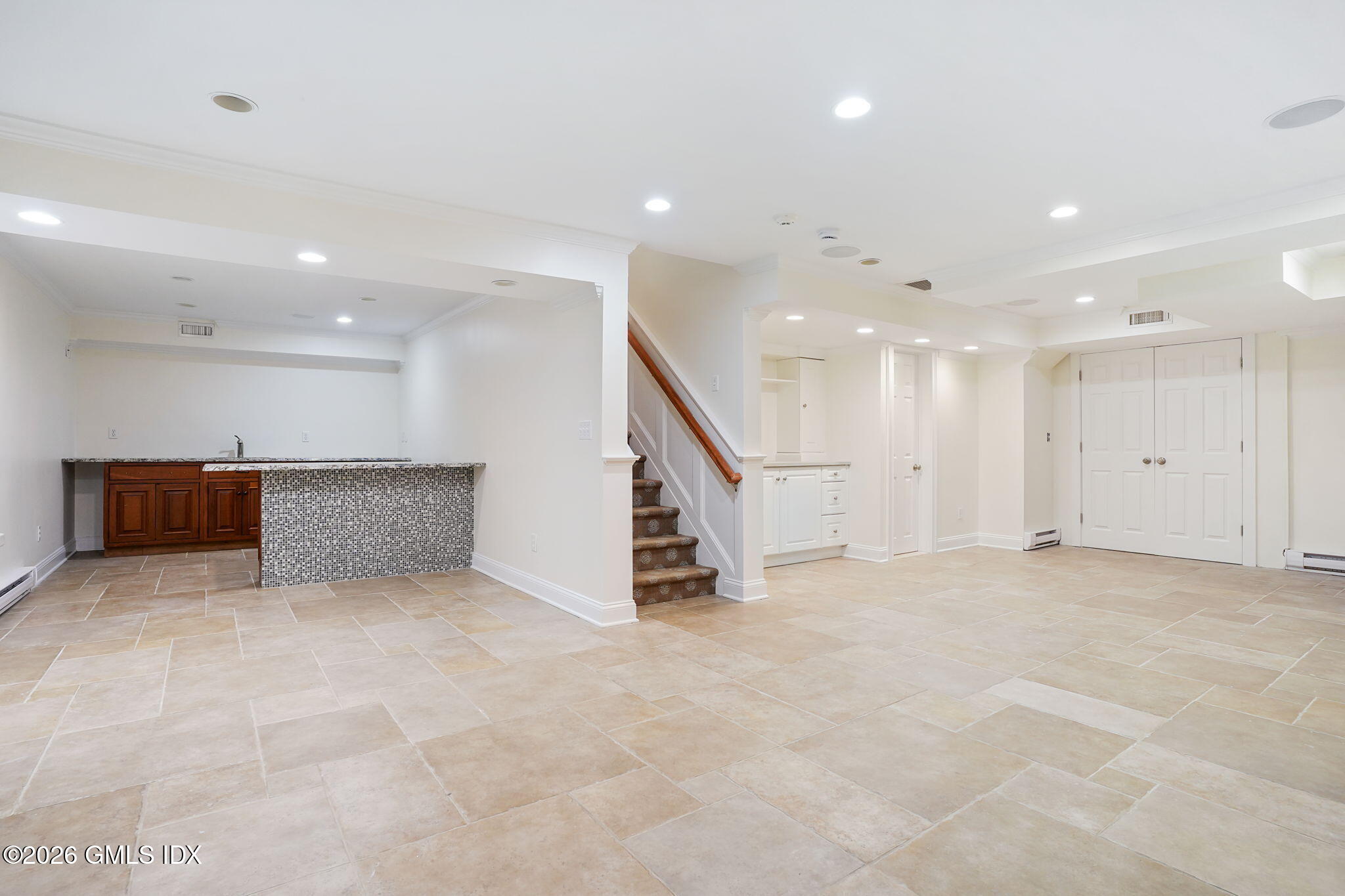 83 Westport Road Wilton, CT 06897 - Photo 31 of 45 an empty room with white walls and stairs