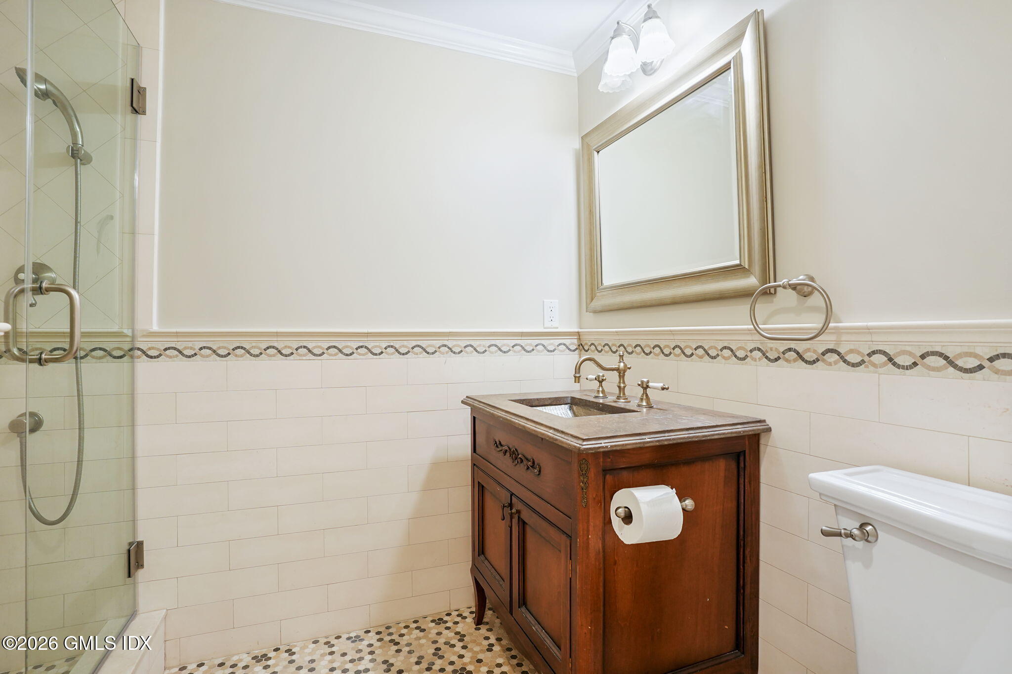 83 Westport Road Wilton, CT 06897 - Photo 33 of 45 a bathroom with a sink a toilet and a mirror