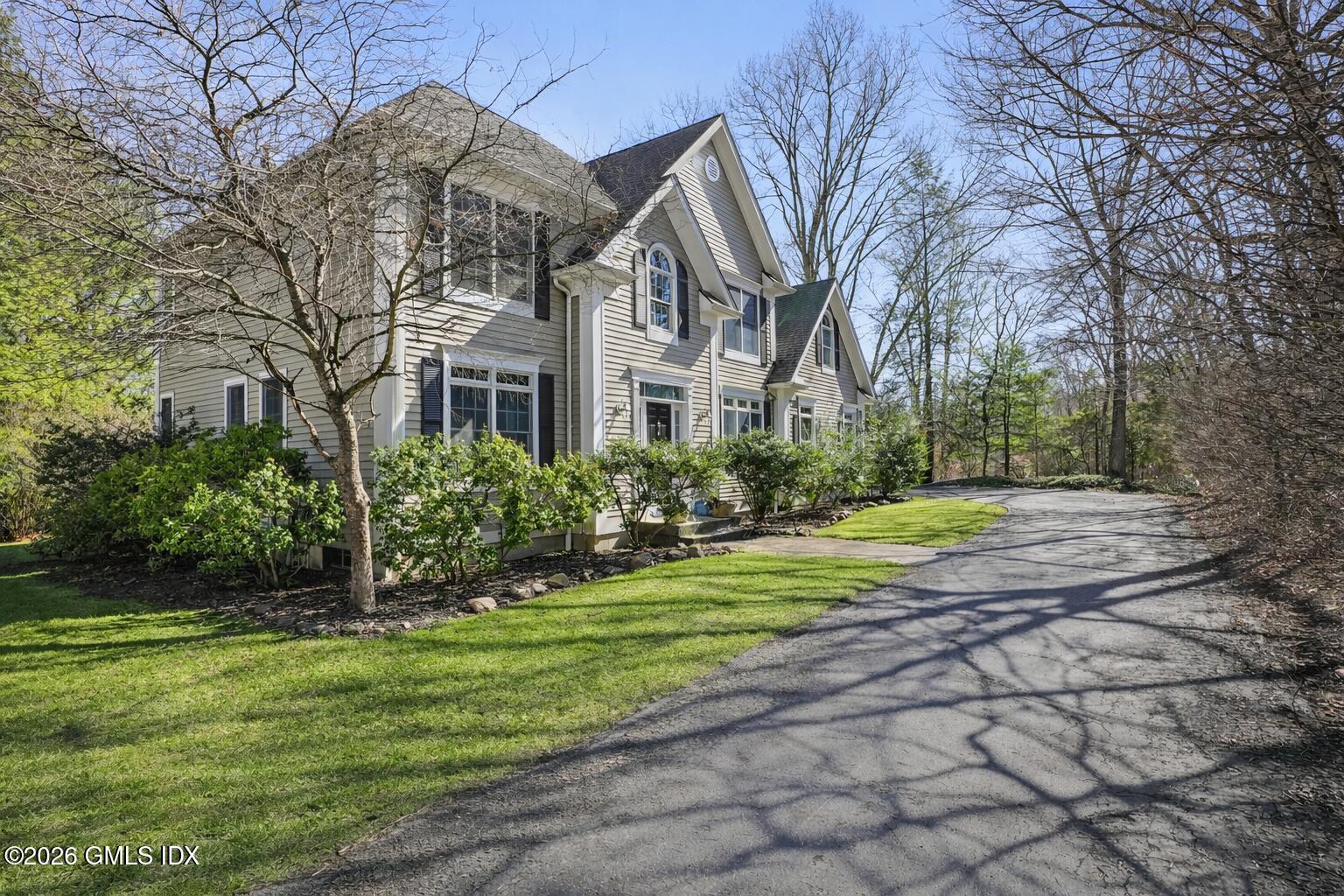 83 Westport Road Wilton, CT 06897 - Photo 35 of 45 a front view of a house with a yard