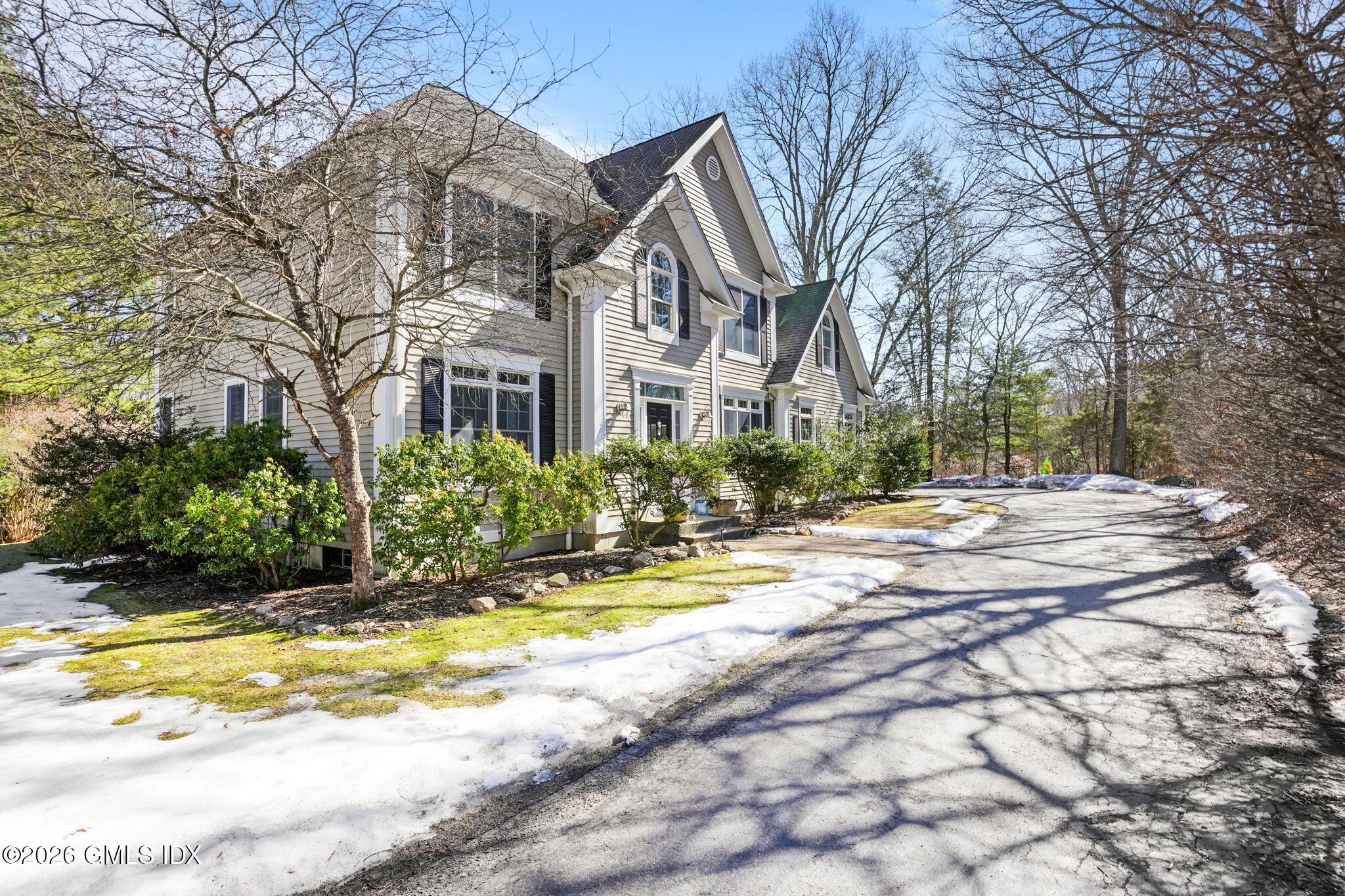 83 Westport Road Wilton, CT 06897 - Photo 36 of 45 a view of swimming pool with large trees and wooden fence