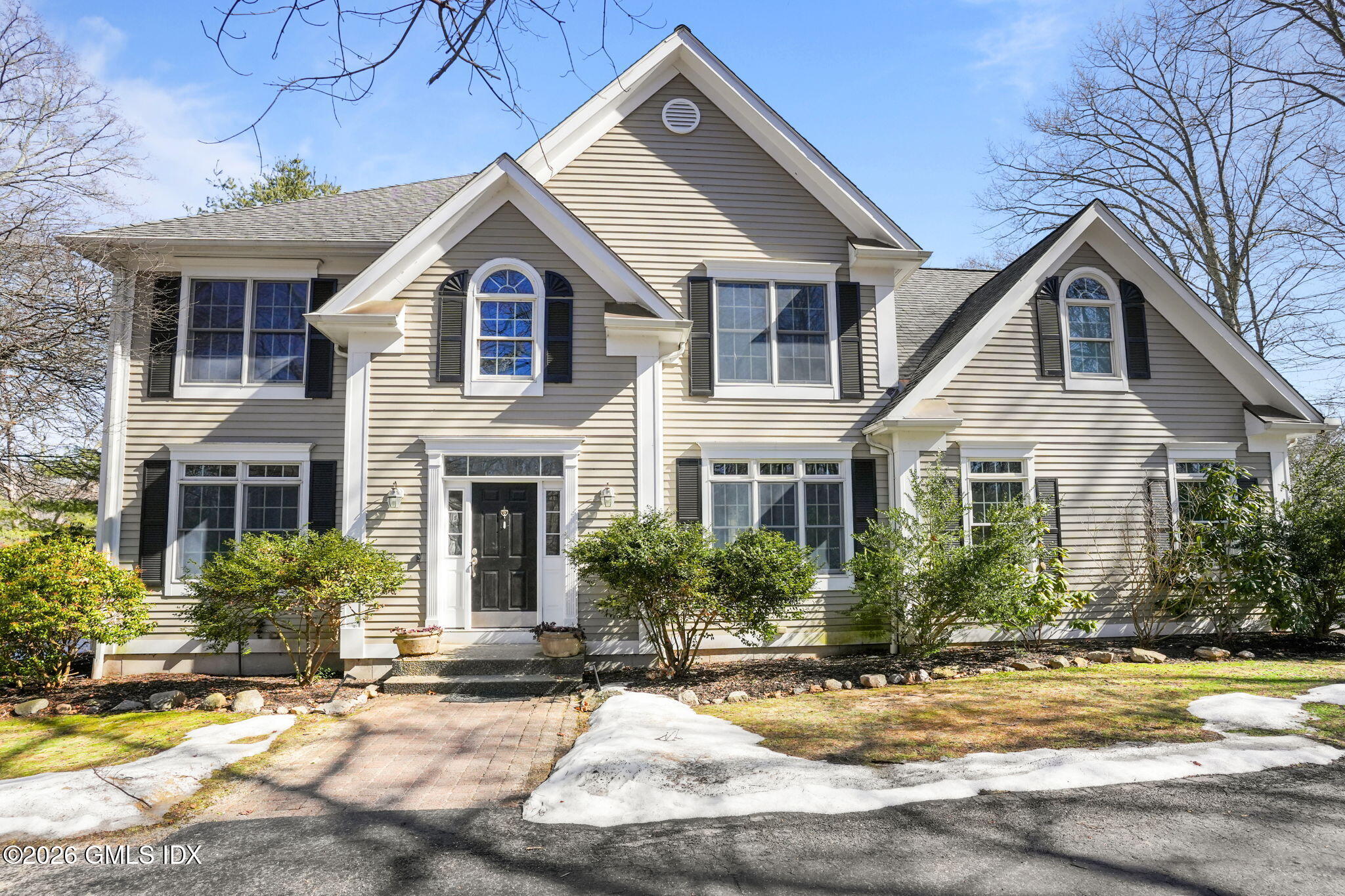 83 Westport Road Wilton, CT 06897 - Photo 45 of 45 a view of a white house with a large windows and plants