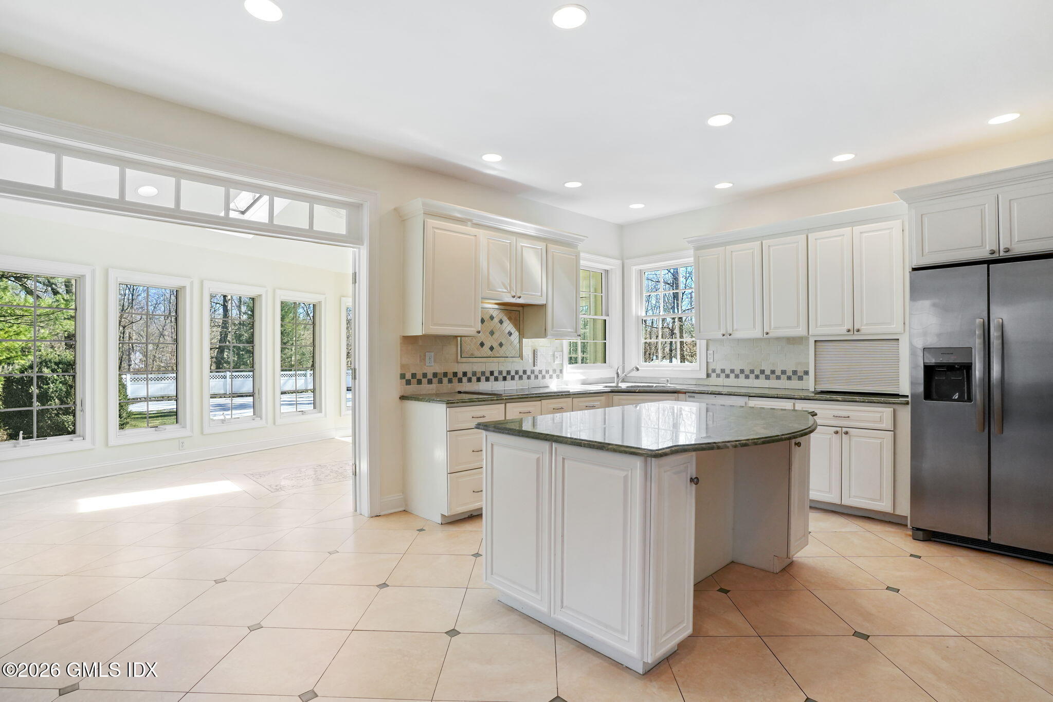 83 Westport Road Wilton, CT 06897 - Photo 9 of 45 a large kitchen with kitchen island a large counter top space a sink stainless steel appliances and cabinets