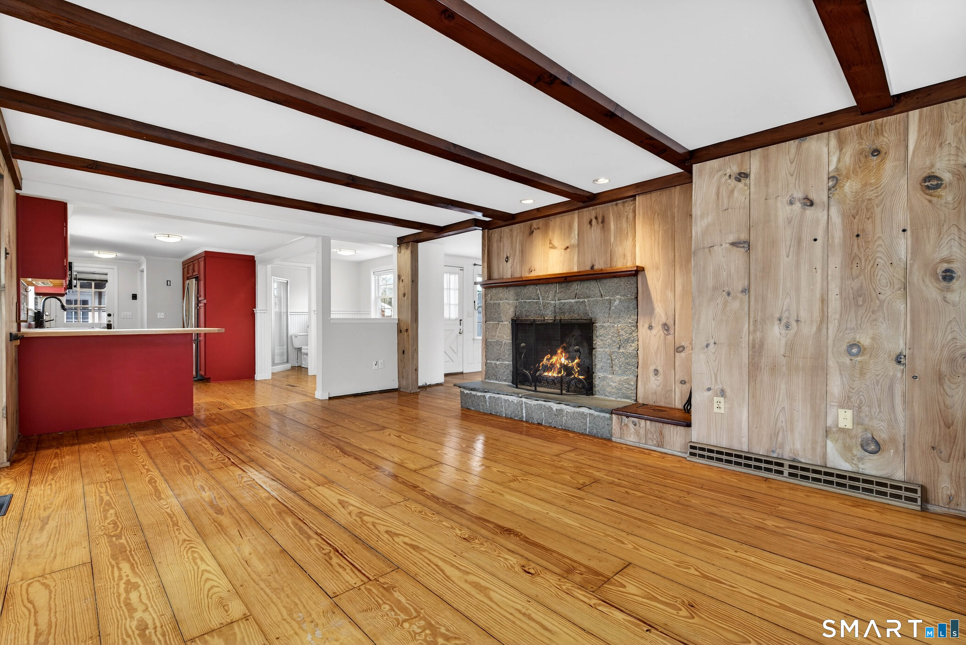 25 Pond Road Old Saybrook, CT 06475 - Photo 11 of 40 a view of an empty room with wooden floor and a fireplace