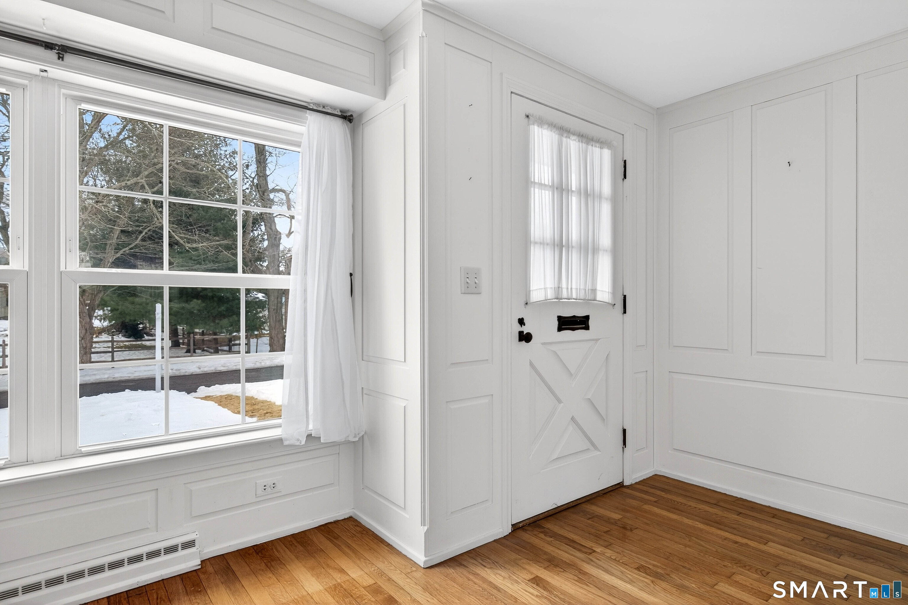 25 Pond Road Old Saybrook, CT 06475 - Photo 3 of 40 a view of an empty room with a window and wooden floor
