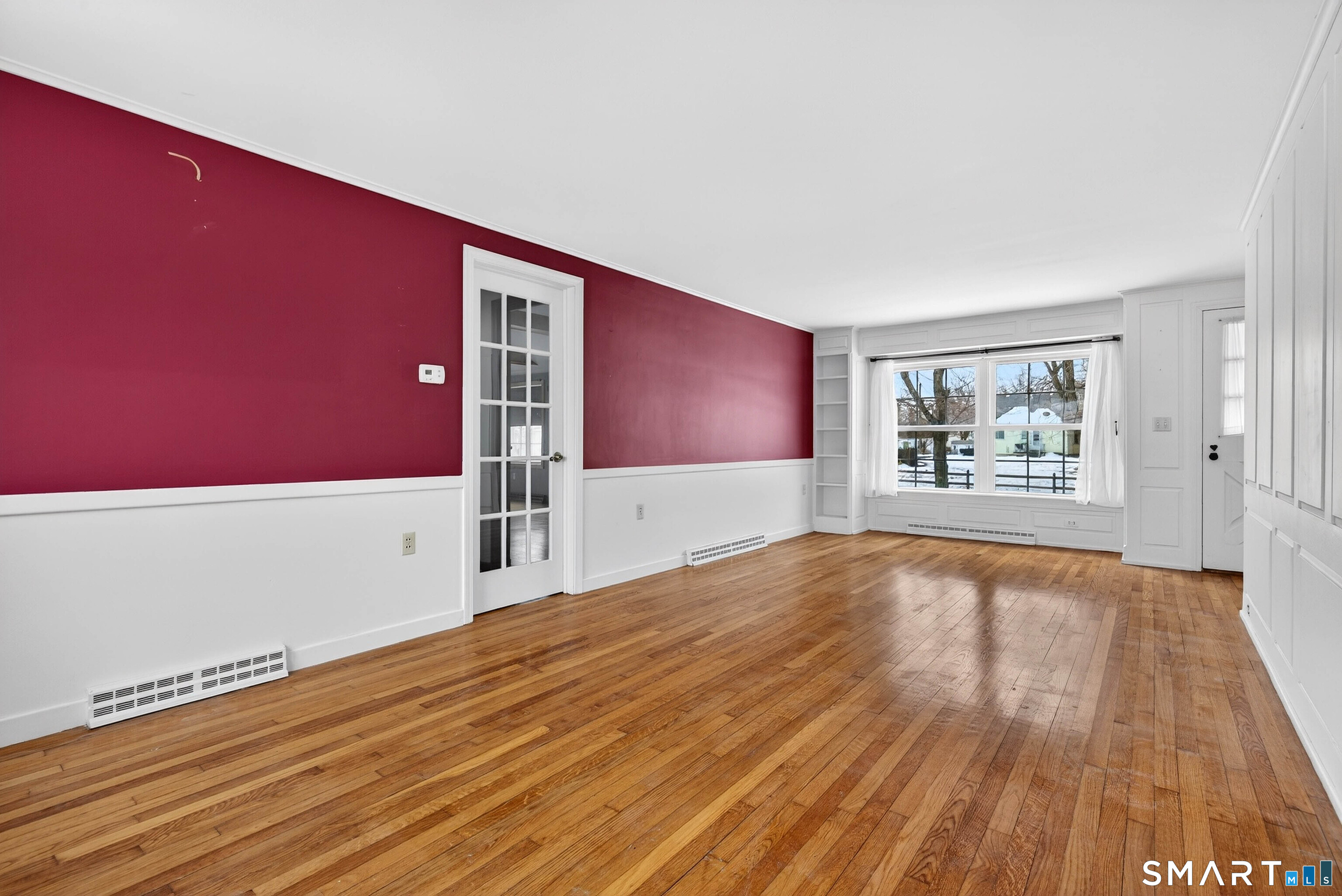25 Pond Road Old Saybrook, CT 06475 - Photo 5 of 40 a view of an empty room with window and wooden floor