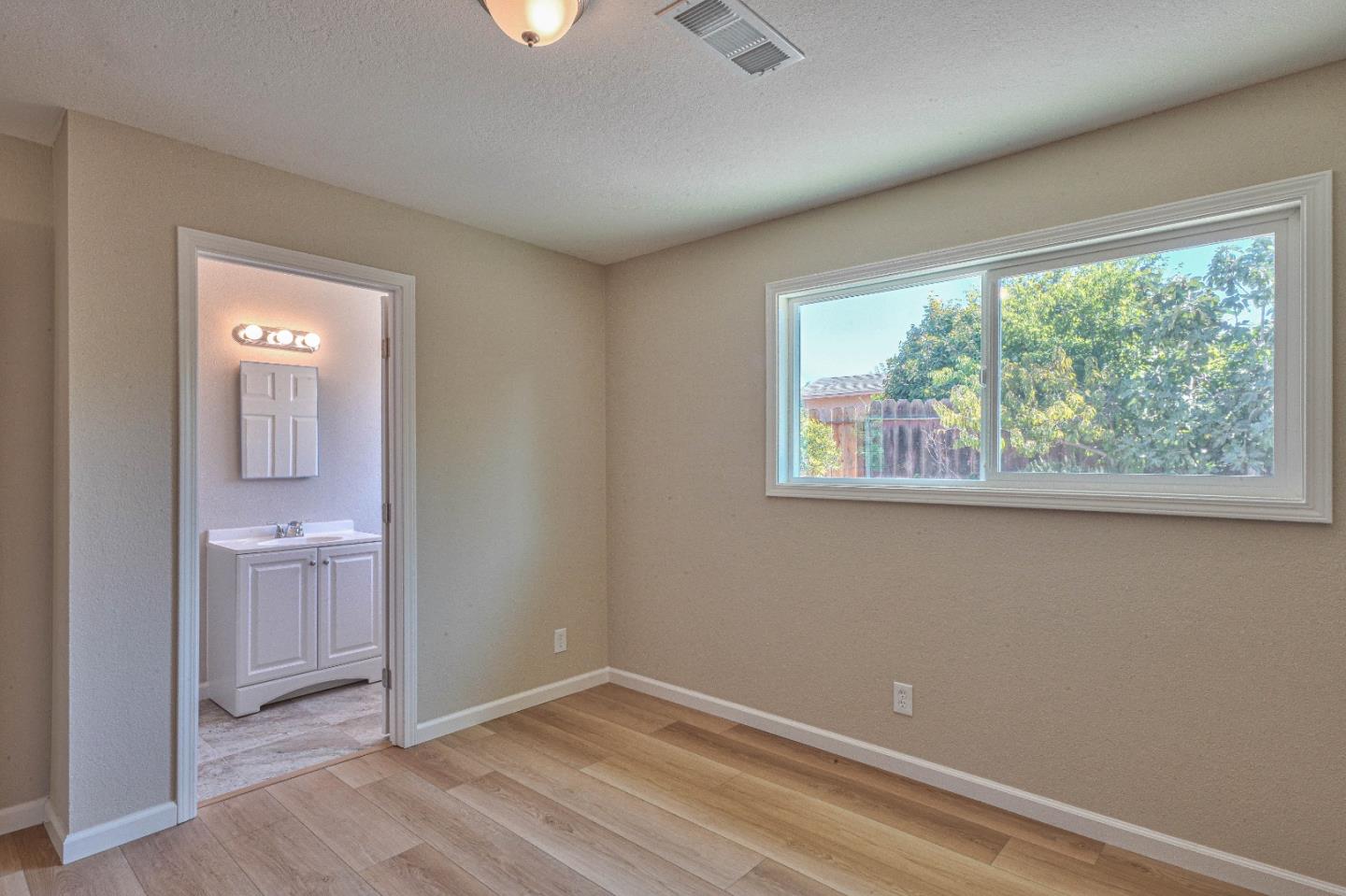104 Inca Drive Soledad, CA 93960 - Photo 15 of 28 an empty room with a window and wooden floor