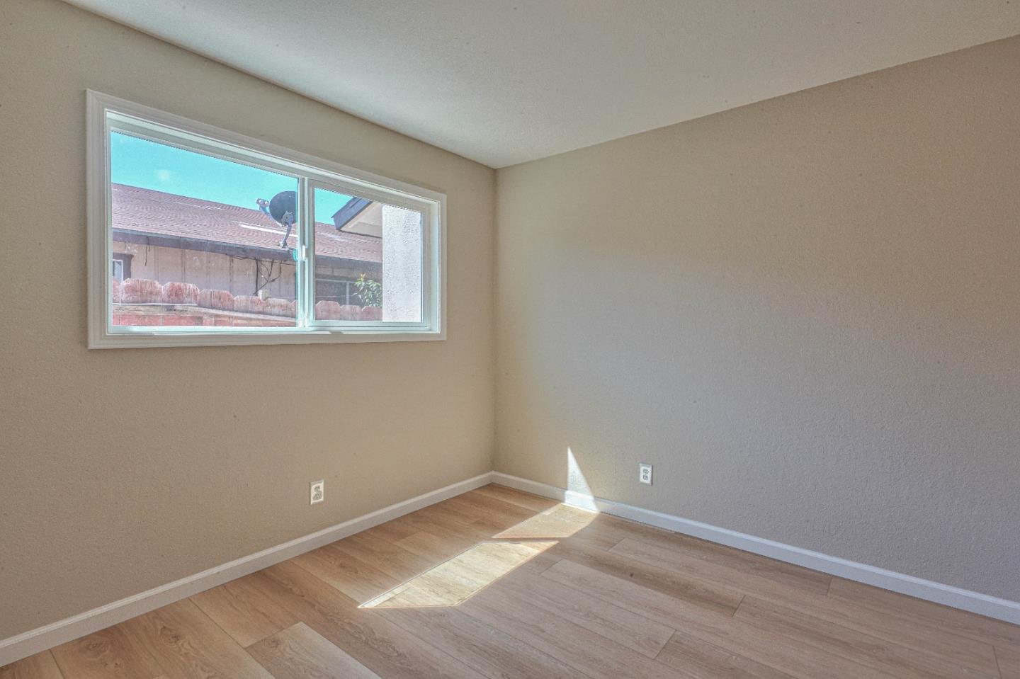 104 Inca Drive Soledad, CA 93960 - Photo 18 of 28 a view of an empty room with wooden floor and a window
