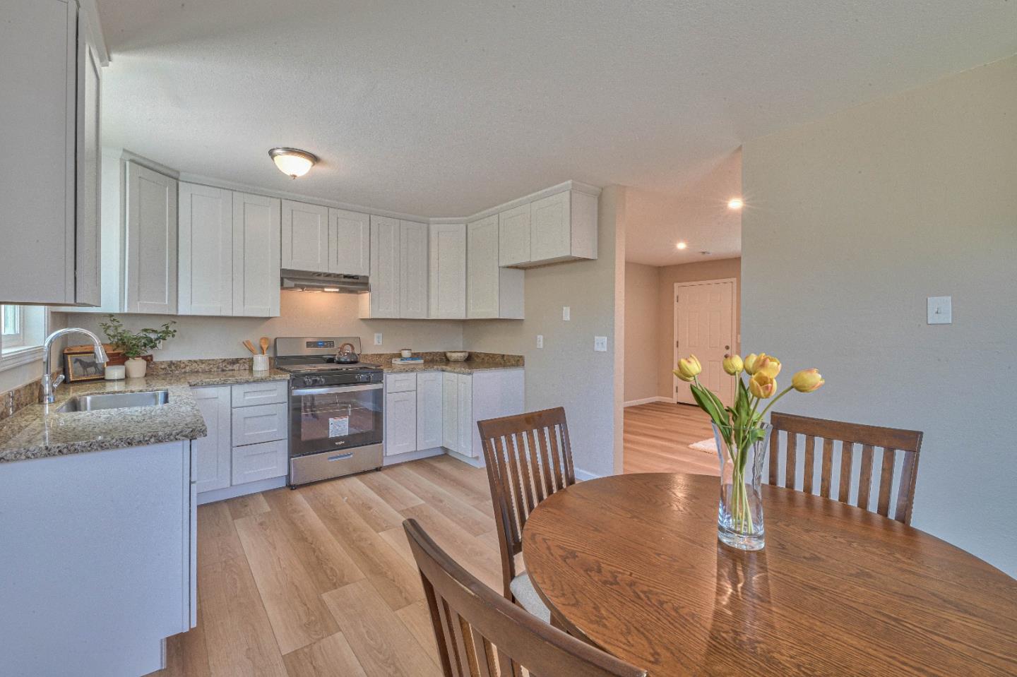 104 Inca Drive Soledad, CA 93960 - Photo 9 of 28 a kitchen with granite countertop kitchen island stainless steel appliances a dining table a sink a stove a dining table and chairs