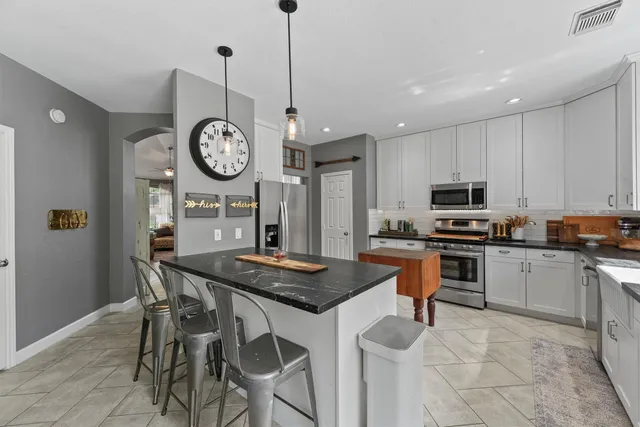 a kitchen with a table chairs and cabinets