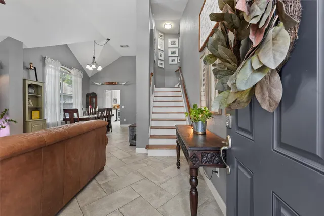 a living room with furniture and a chandelier