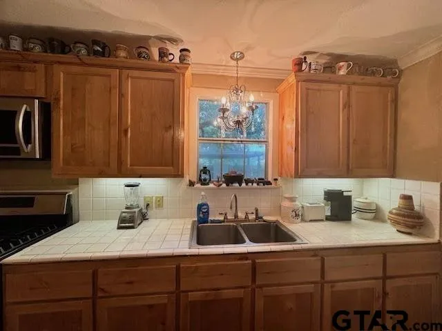 a kitchen with a sink cabinets and window