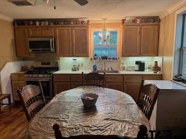 a kitchen with a stove a sink and a microwave