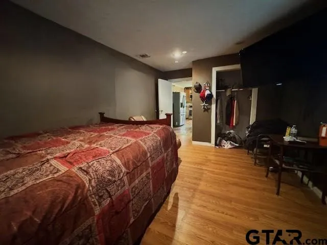 a bed room with a bed and a television