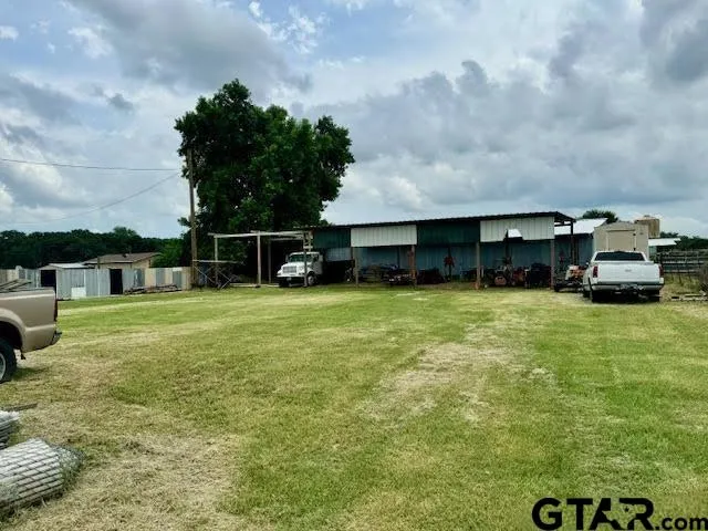 a car parked in front of a house with a yard
