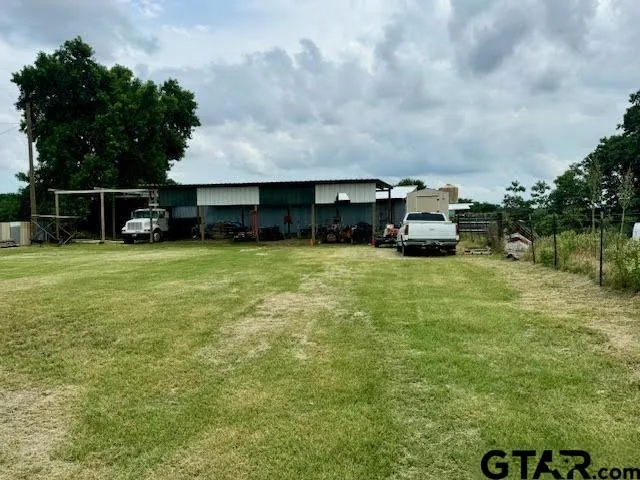 a view of a house with yard and sitting area