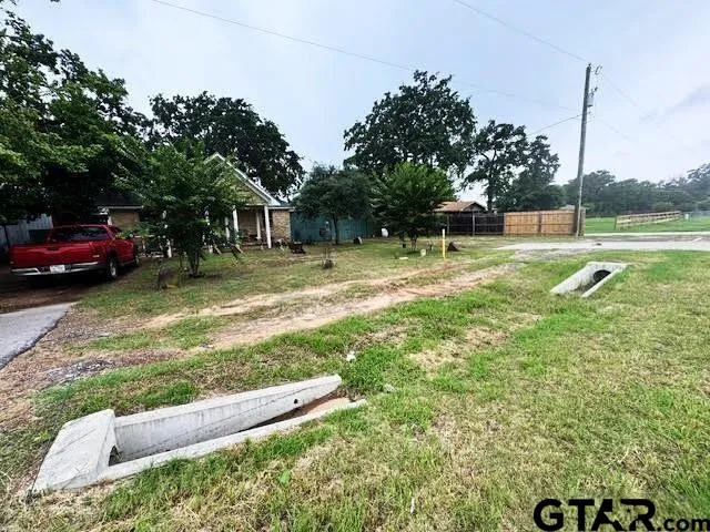a view of a backyard with a garden and entertaining space