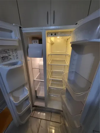 a kitchen with stainless steel appliances granite countertop a refrigerator and a stove