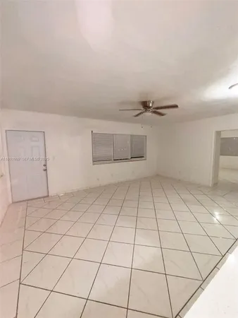 a view of a livingroom with wooden floor and a hallway