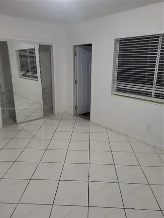 a bathroom with a white toilet and sink