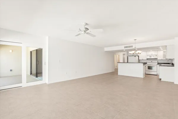 a view of a kitchen with furniture and a ceiling fan