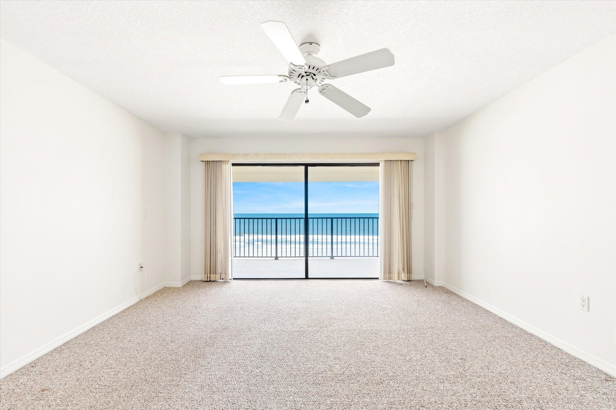 8090 A1A South, Unit 406 St. Augustine, FL 32080 - Photo 17 of 42 an empty room with a ceiling fan and a window