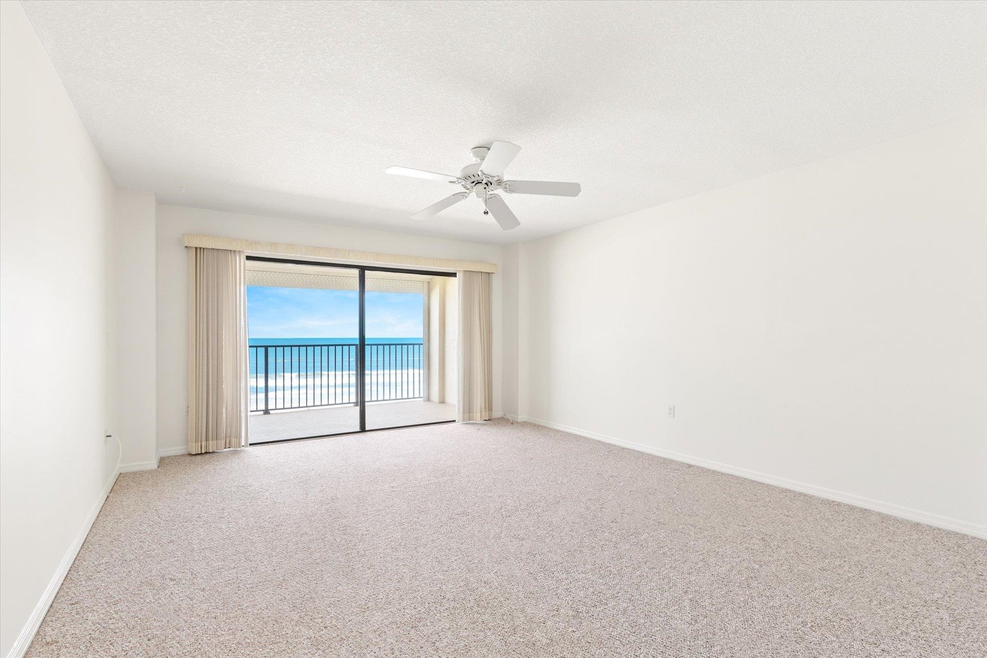 8090 A1A South, Unit 406 St. Augustine, FL 32080 - Photo 18 of 42 an empty room with a ceiling fan and a window