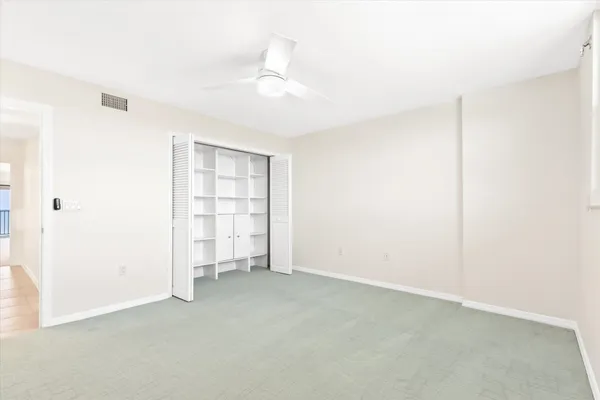 an empty room with a empty space and windows