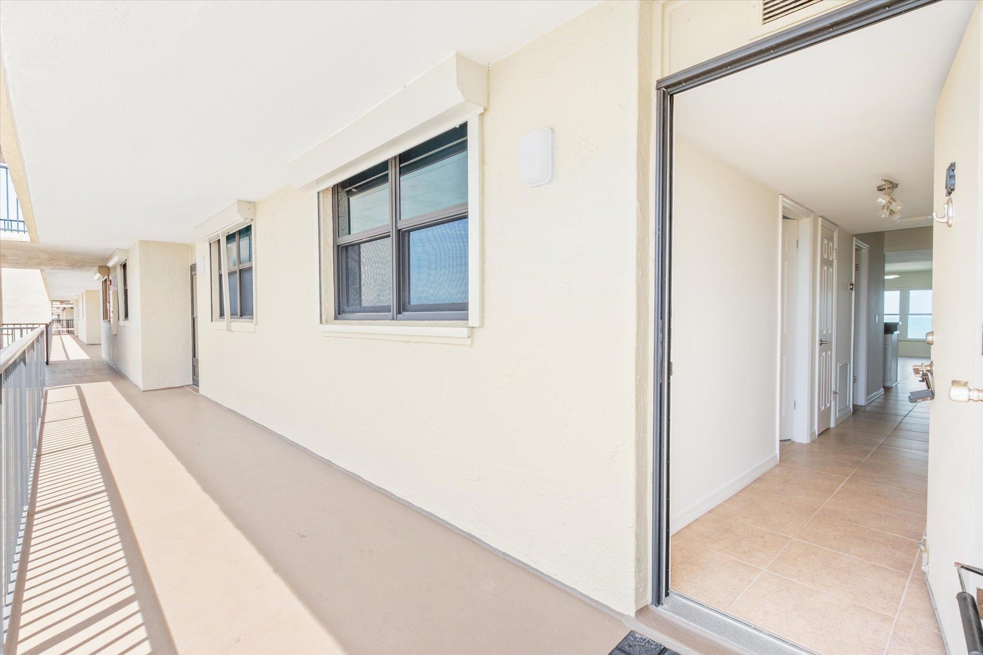 8090 A1A South, Unit 406 St. Augustine, FL 32080 - Photo 28 of 42 a view of a hallway with wooden floor and staircase