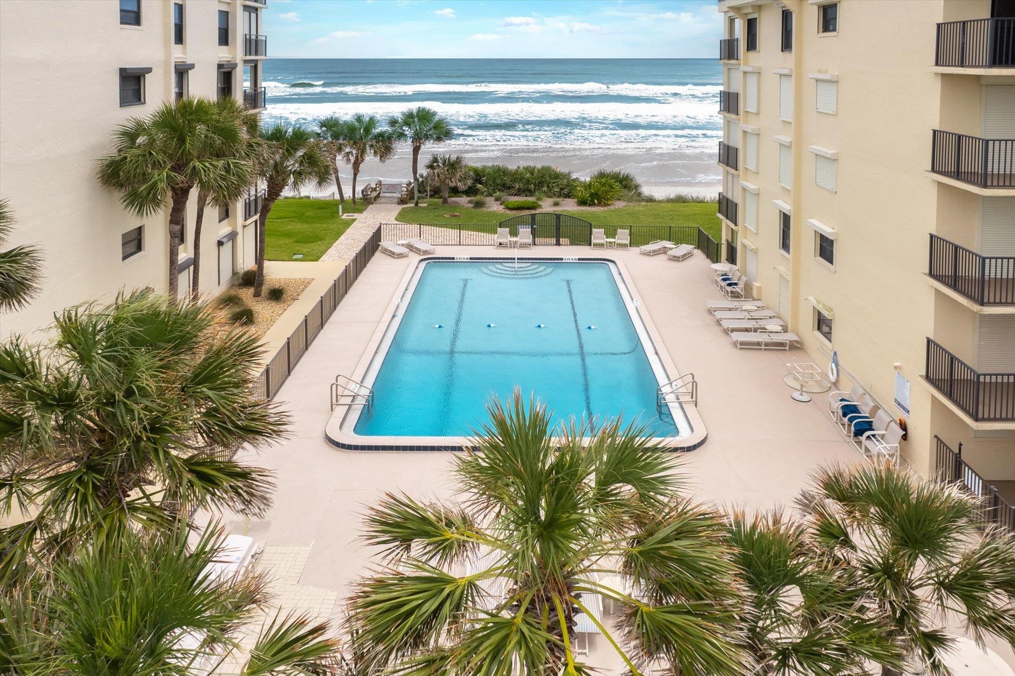 8090 A1A South, Unit 406 St. Augustine, FL 32080 - Photo 32 of 42 a view of swimming pool from a balcony