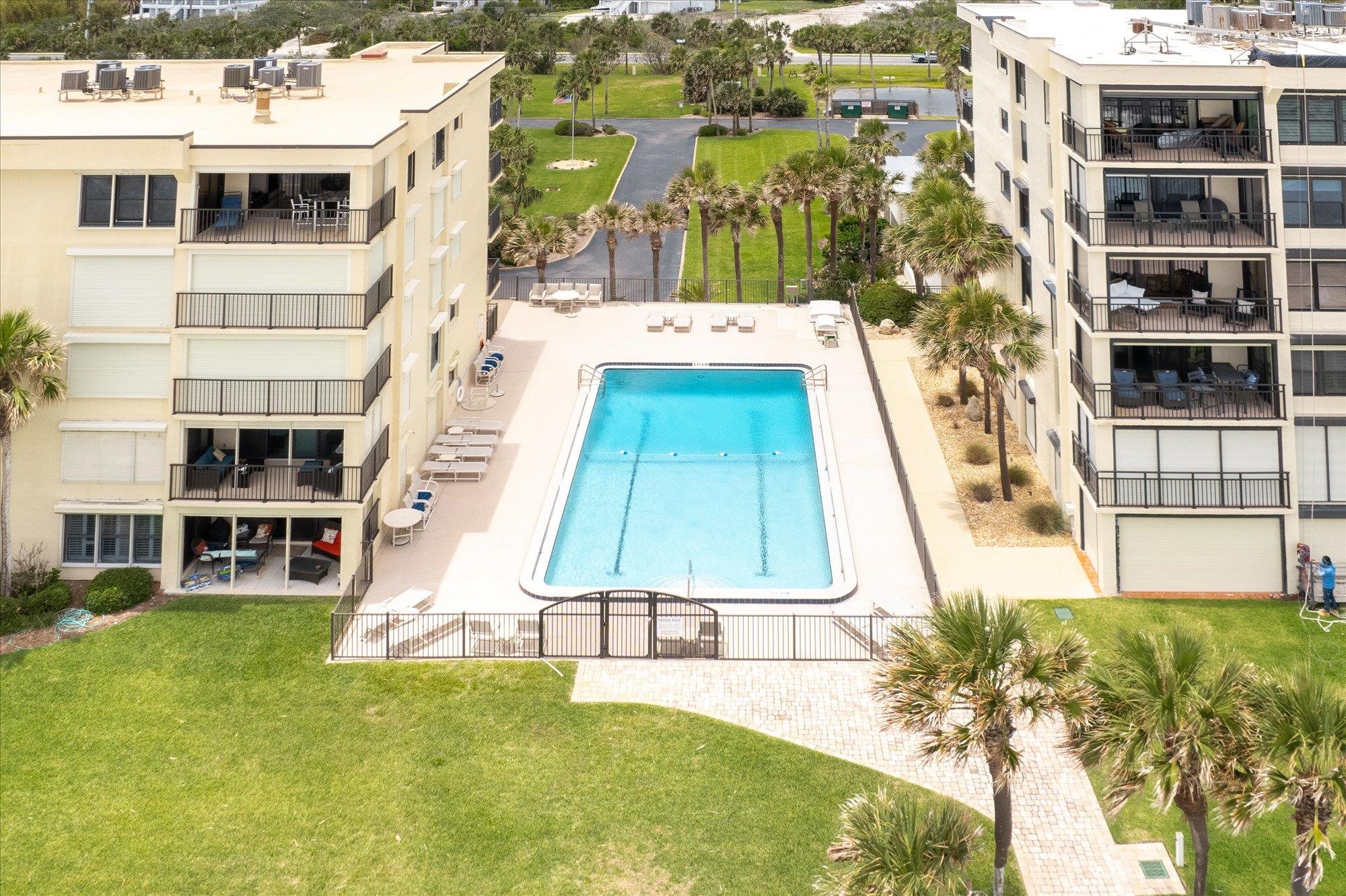 8090 A1A South, Unit 406 St. Augustine, FL 32080 - Photo 33 of 42 a white bench sitting in front of a building