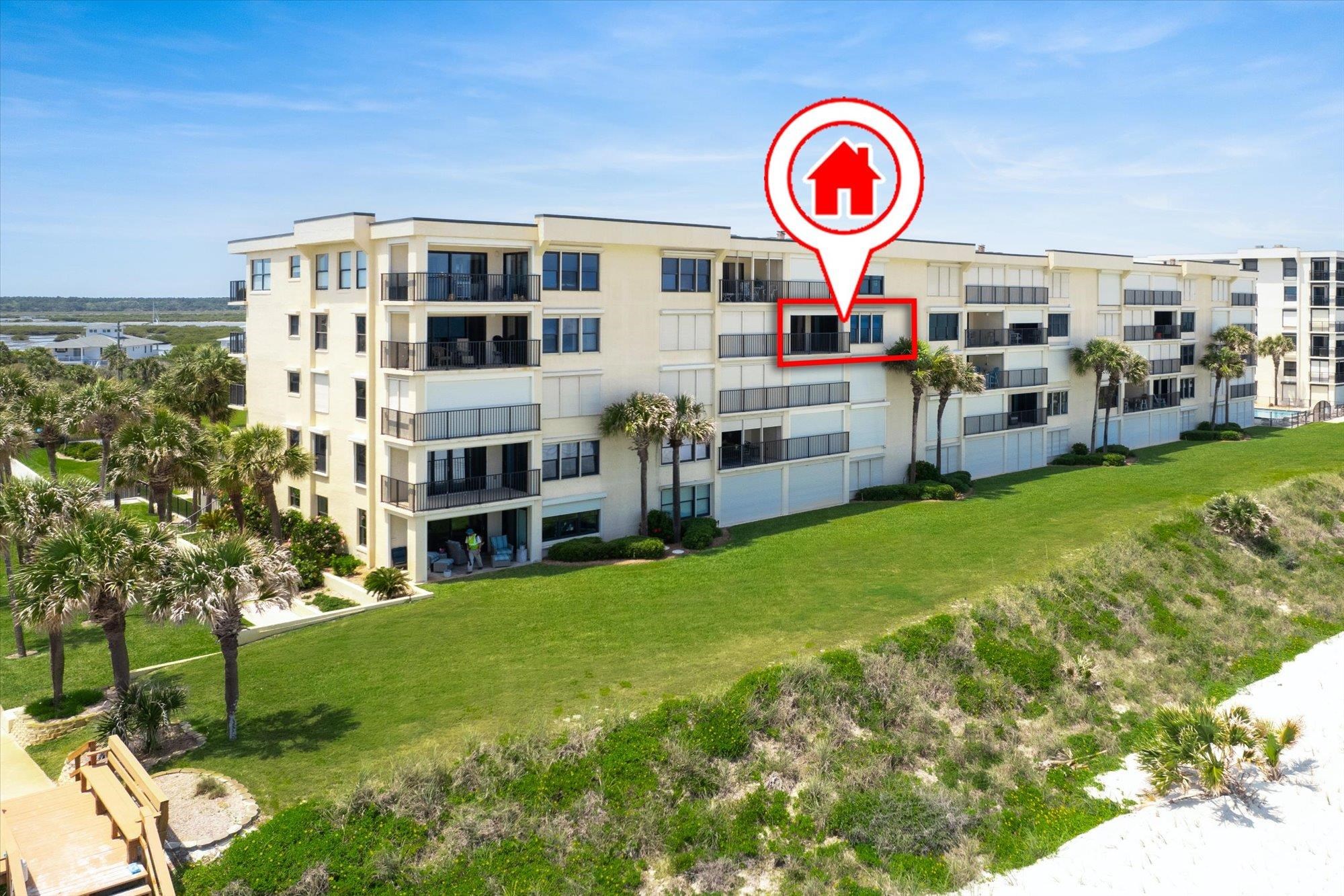 8090 A1A South, Unit 406 St. Augustine, FL 32080 - Photo 36 of 42 a view of a house with swimming pool and a yard