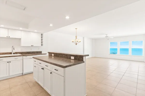 a kitchen with granite countertop a sink and cabinets